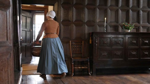 Costumed interpreter leaving the Great Parlour at Little Moreton Hall, Cheshire